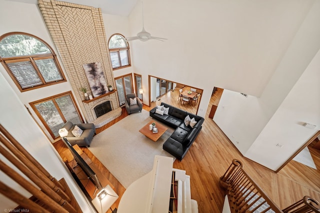 396 Crestwood Rd, Wood Dale, IL 60191 - living room with a high ceiling, ceiling fan, a fireplace, and wood finished floors
