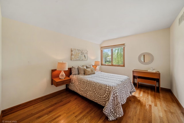 396 Crestwood Rd, Wood Dale, IL 60191 - bedroom with wood finished floors, lofted ceiling, and baseboards