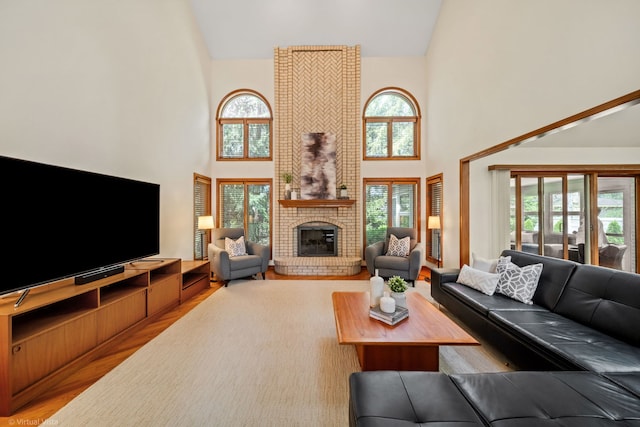 396 Crestwood Rd, Wood Dale, IL 60191 - living room featuring high vaulted ceiling, light wood finished floors, and a fireplace