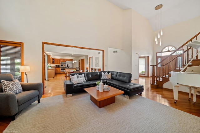 396 Crestwood Rd, Wood Dale, IL 60191 - living room featuring a high ceiling, light wood-type flooring, and stairway
