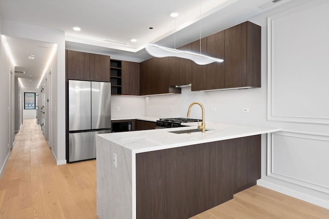 2248 W N Ave Unit 2, Chicago, IL 60647 - kitchen with modern cabinets, open shelves, dark brown cabinets, freestanding refrigerator, and a peninsula