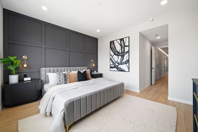 2248 W N Ave Unit 2, Chicago, IL 60647 - bedroom featuring baseboards, recessed lighting, light wood finished floors, and a decorative wall