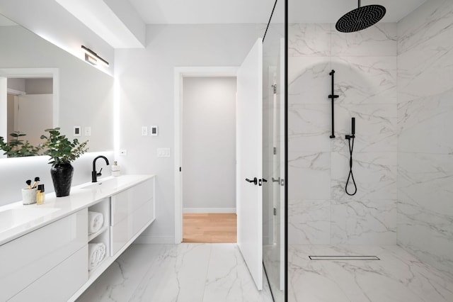 2248 W N Ave Unit 2, Chicago, IL 60647 - bathroom featuring double vanity, a sink, baseboards, marble finish floor, and a marble finish shower
