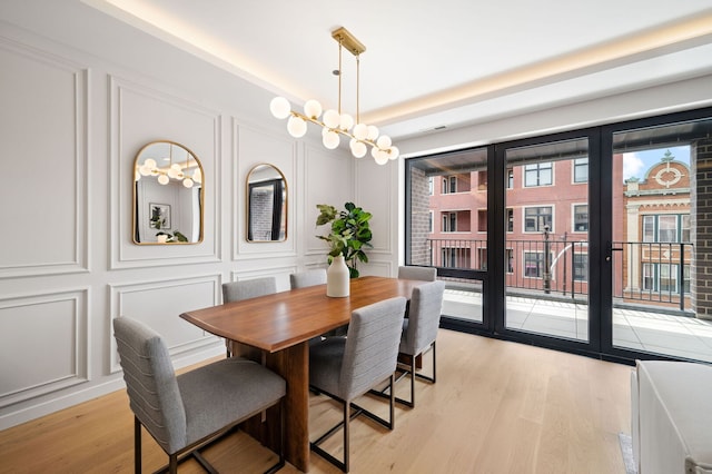 2248 W N Ave Unit 2, Chicago, IL 60647 - dining area with french doors, light wood-style floors, and a decorative wall
