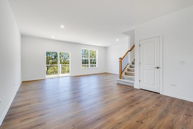 3705 Neubauer Cir Unit 103, Lindenhurst, IL 60046 - unfurnished living room featuring stairs, wood finished floors, recessed lighting, and baseboards