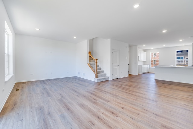 3705 Neubauer Cir Unit 103, Lindenhurst, IL 60046 - unfurnished living room with stairs, light wood-type flooring, recessed lighting, and baseboards