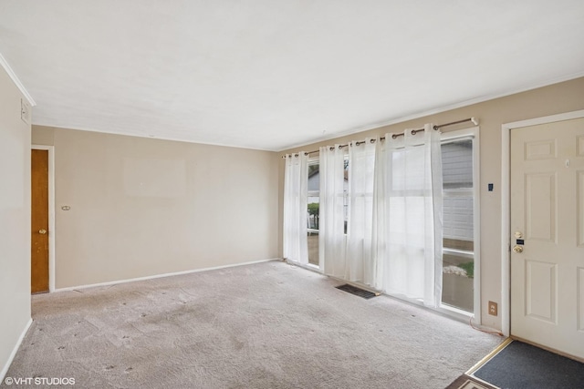 spare room with carpet flooring and baseboards