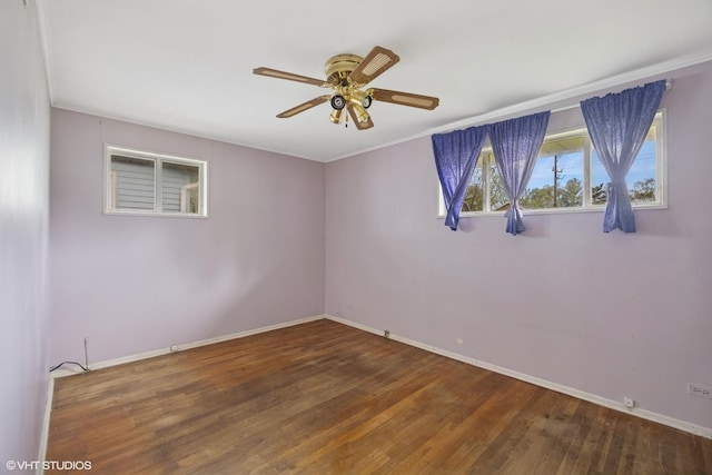 unfurnished room featuring baseboards, a ceiling fan, wood finished floors, and crown molding