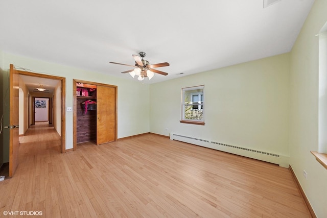 7010 W Devon Ave, Chicago, IL 60631 - unfurnished bedroom with a baseboard radiator, light wood-style floors, a closet, baseboards, and ceiling fan