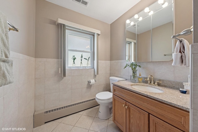 7010 W Devon Ave, Chicago, IL 60631 - bathroom with a baseboard radiator, tile patterned floors, tile walls, toilet, and vanity
