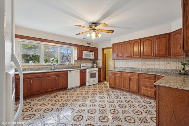 7010 W Devon Ave, Chicago, IL 60631 - kitchen with white appliances, ceiling fan, and brown cabinetry