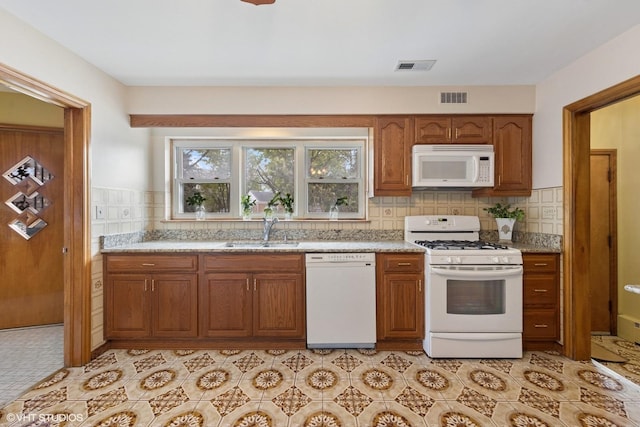 7010 W Devon Ave, Chicago, IL 60631 - kitchen with white appliances, a sink, brown cabinets, and backsplash