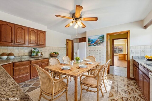 7010 W Devon Ave, Chicago, IL 60631 - dining space with ceiling fan and tile walls