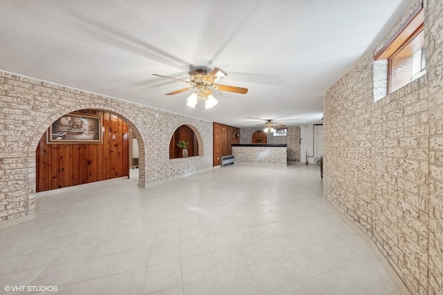7010 W Devon Ave, Chicago, IL 60631 - unfurnished living room featuring ceiling fan, arched walkways, and a fireplace