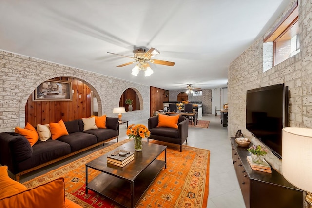 7010 W Devon Ave, Chicago, IL 60631 - living room featuring ceiling fan, arched walkways, a fireplace, and light flooring