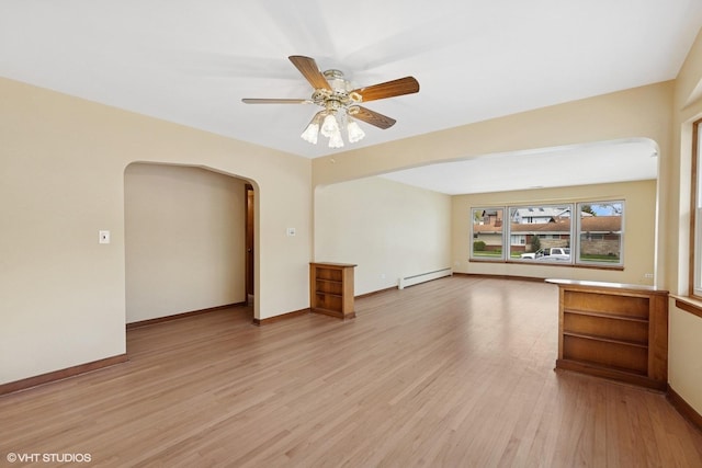 7010 W Devon Ave, Chicago, IL 60631 - unfurnished living room featuring arched walkways, a baseboard radiator, light wood-style floors, a ceiling fan, and baseboards
