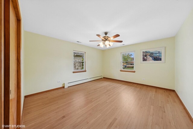 7010 W Devon Ave, Chicago, IL 60631 - unfurnished room featuring baseboard heating, a ceiling fan, baseboards, and light wood-style flooring