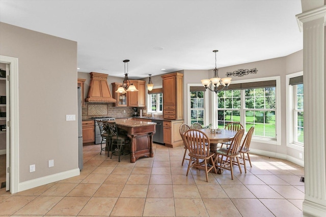 dining area with a chandelier, baseboards, healthy amount of natural light, light tile patterned floors, and recessed lighting
