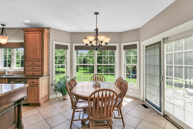 dining space with a chandelier, light tile patterned floors, baseboards, and recessed lighting