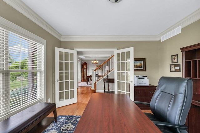 home office featuring french doors, a chandelier, ornamental molding, and wood finished floors