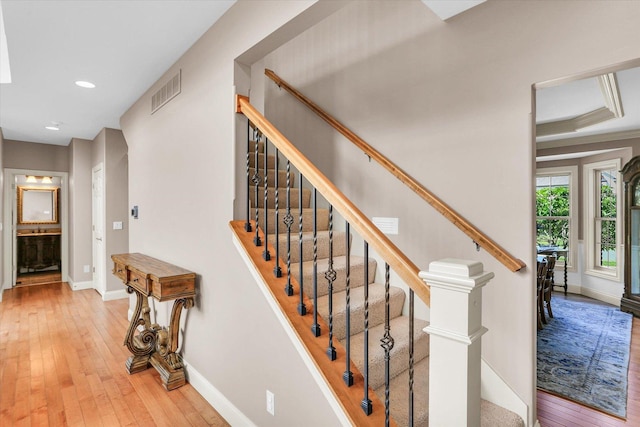 stairway with baseboards, hardwood / wood-style flooring, and recessed lighting