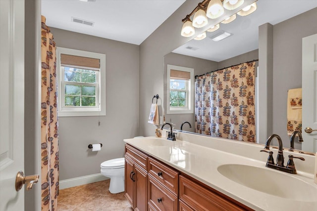 full bath featuring baseboards, toilet, double vanity, and tile patterned floors
