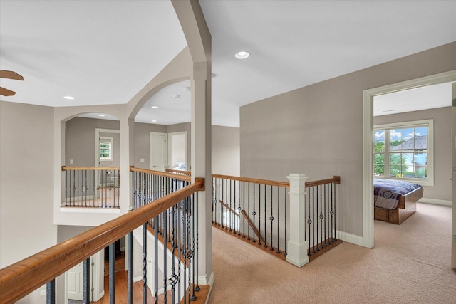 hall featuring an upstairs landing, carpet flooring, baseboards, and recessed lighting