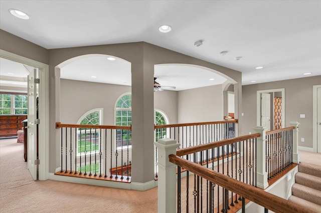 corridor with carpet floors, an upstairs landing, plenty of natural light, and recessed lighting