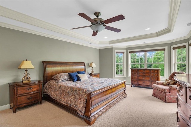 bedroom with light colored carpet, a raised ceiling, ornamental molding, baseboards, and ceiling fan