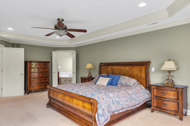 bedroom featuring a tray ceiling, carpet floors, ornamental molding, recessed lighting, and ensuite bath