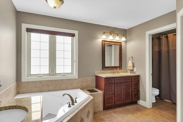 bathroom with a whirlpool tub, toilet, vanity, and tile patterned flooring
