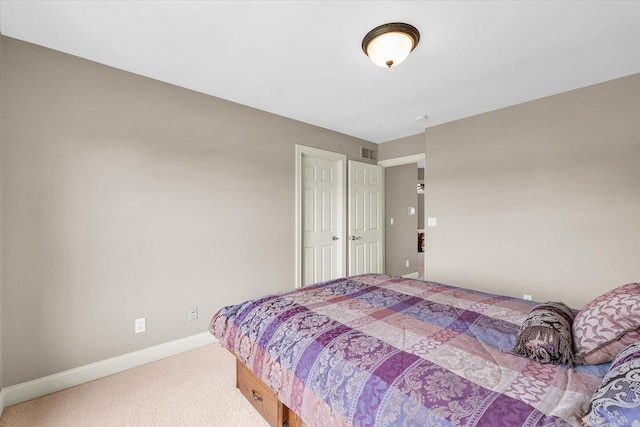 bedroom featuring carpet and baseboards