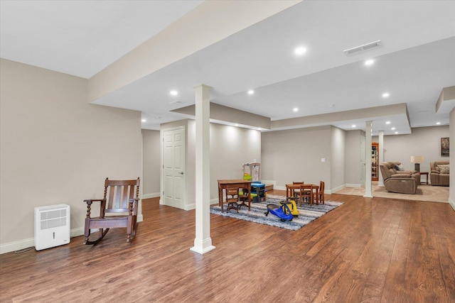 exercise area with wood finished floors, baseboards, and recessed lighting