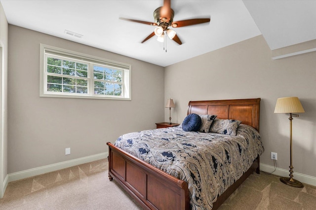 bedroom featuring light carpet, baseboards, and ceiling fan
