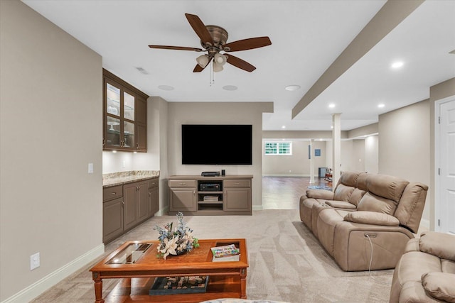 living room featuring baseboards, ceiling fan, and recessed lighting