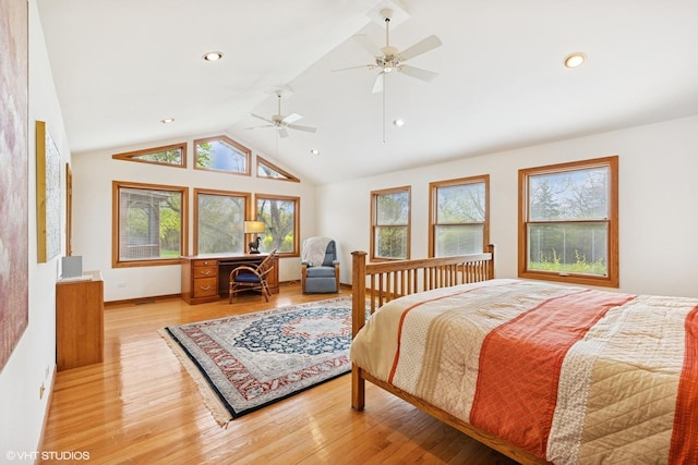 bedroom featuring multiple windows, vaulted ceiling, and light wood finished floors