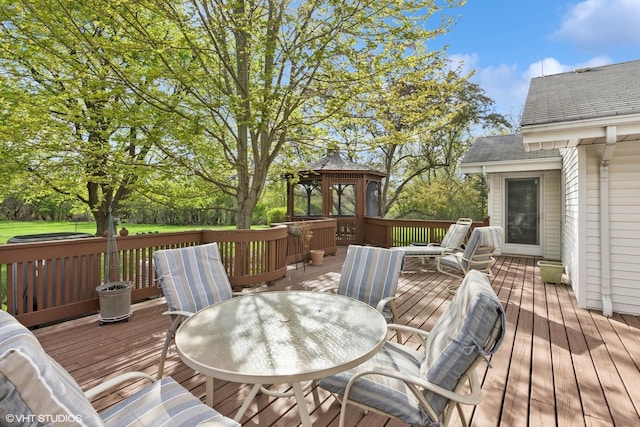 deck with outdoor dining space and a gazebo