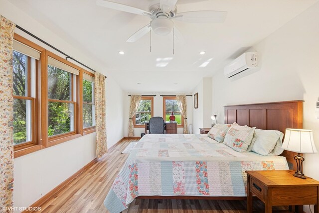 bedroom featuring light wood-style floors, baseboards, ceiling fan, recessed lighting, and a wall unit AC