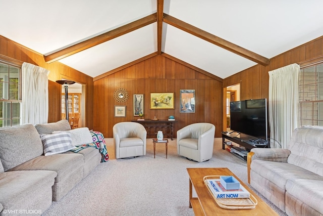 carpeted living area featuring lofted ceiling with beams and wood walls