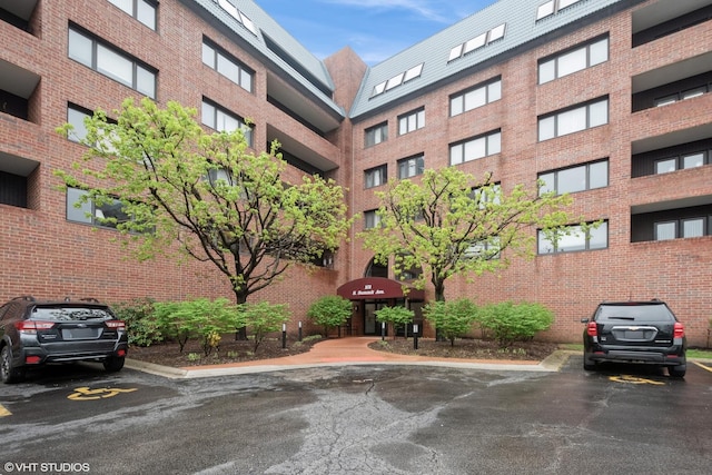 view of property featuring uncovered parking