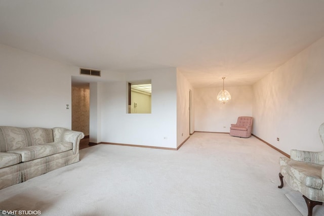 unfurnished living room with visible vents, baseboards, a chandelier, and light carpet