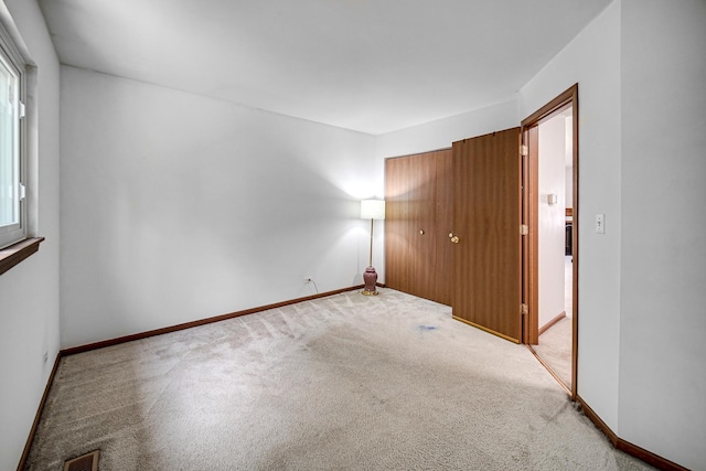 713 Arbury Ct, Romeoville, IL 60446 - unfurnished bedroom with carpet, a closet, and baseboards