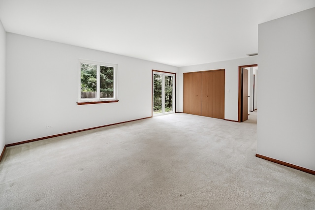 713 Arbury Ct, Romeoville, IL 60446 - unfurnished bedroom featuring light colored carpet, baseboards, and access to outside