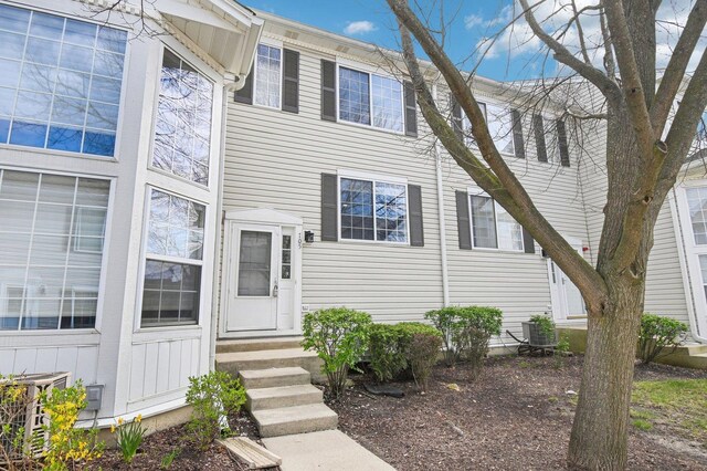 view of front of property with entry steps and central AC