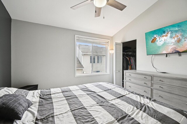 bedroom featuring ceiling fan, a closet, and lofted ceiling