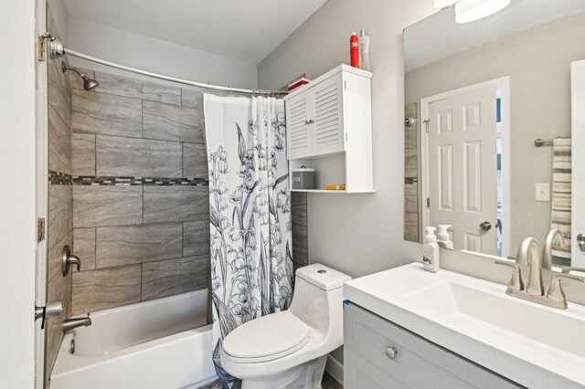 bathroom with toilet, shower / bath combination with curtain, and vanity