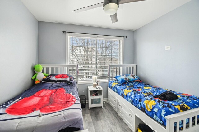 bedroom with ceiling fan and wood finished floors