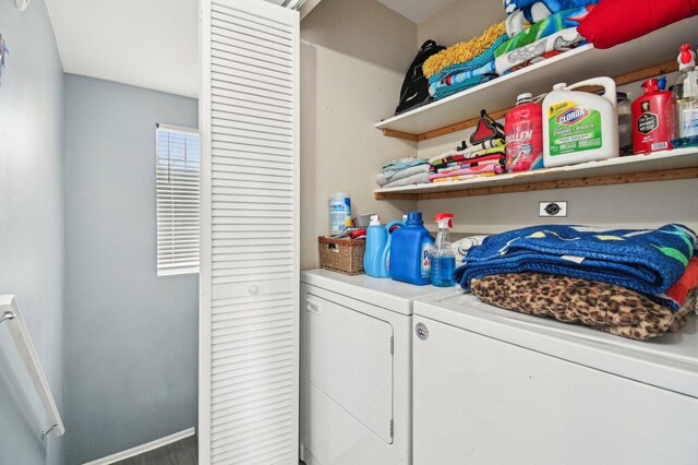 clothes washing area featuring separate washer and dryer and laundry area