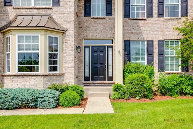 2550 Bayswater Cir, Gurnee, IL 60031 - view of exterior entry featuring brick siding and a standing seam roof