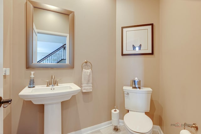 2550 Bayswater Cir, Gurnee, IL 60031 - half bathroom featuring toilet, baseboards, and a sink